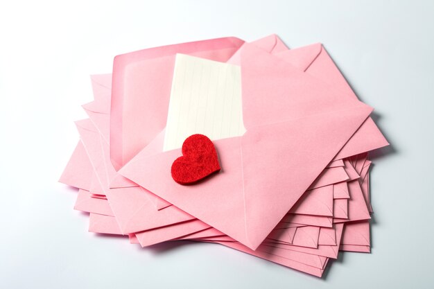 Фото Закрыть штабелирование розовых конвертов и почтовых писем и красное украшение