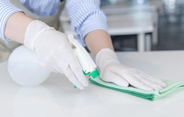 Photo close up staff hand restaurant workers are cleaning table