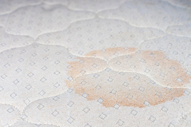 Close-up of the stain on the mattress. The concept of dry cleaning and cleaning, washing of bed linen.