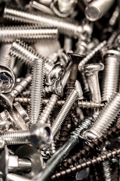 Photo close-up stainless crowd of screws background