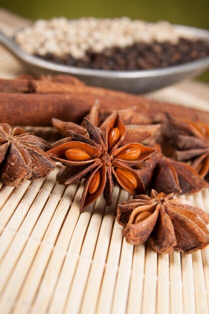 Close-up of star anise and cinnamon sticks in the background