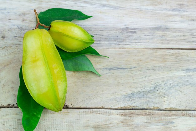 Close up star fruit carambola or star apple starfruit on wood table background star fruit with healthy food top view with copy space