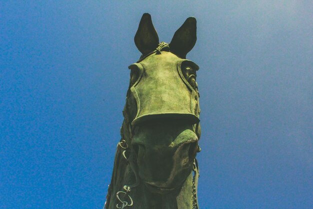 Close-up of statue against blue sky