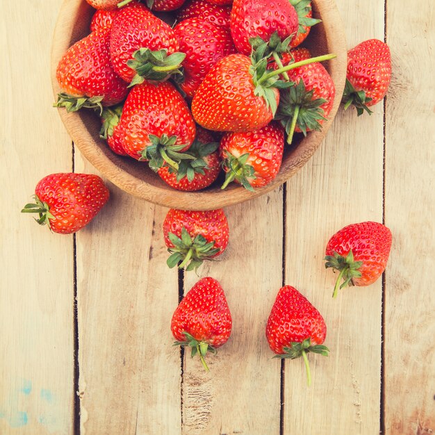 close up stawberry in bowl on wood table