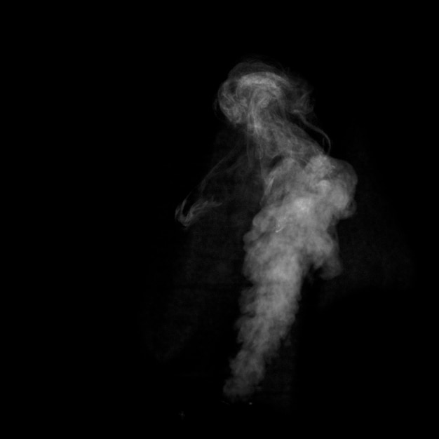 Close up of steam white smoke isolated on black background.