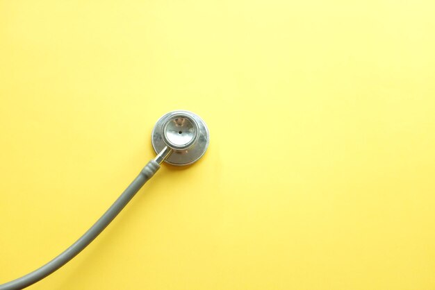 Close-up of stethoscope against yellow background