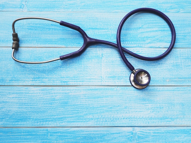 Close up stethoscope on blue wood background with copy space. Healthcare and medical concept. Top view.