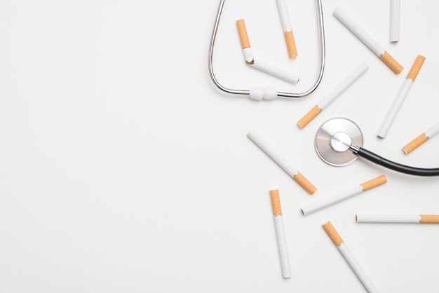 Close-up of stethoscope and cigarettes suggesting a stop smoking theme