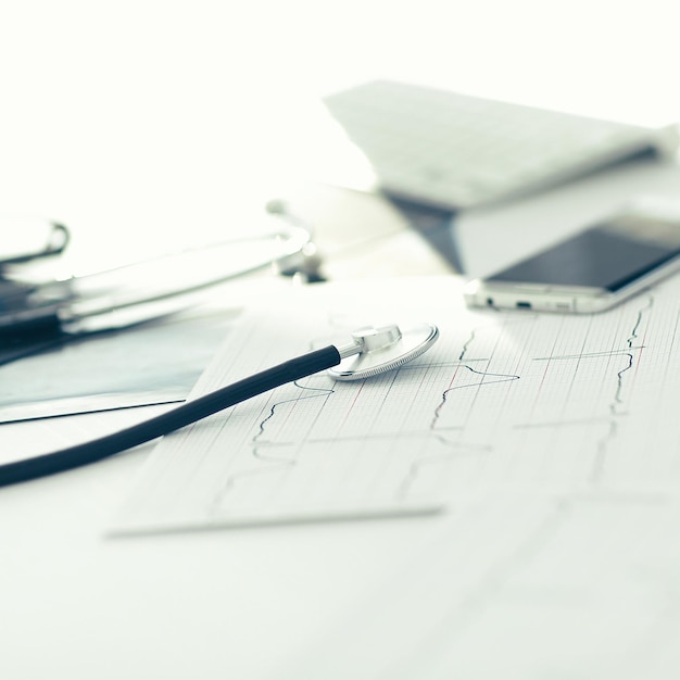 Close up. a stethoscope and a smartphone on the therapist's Desk