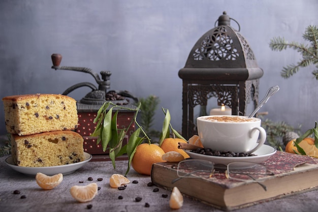 Close-up still life with a book, a geyser coffee maker, Christmas decor on the table. Selective focus.