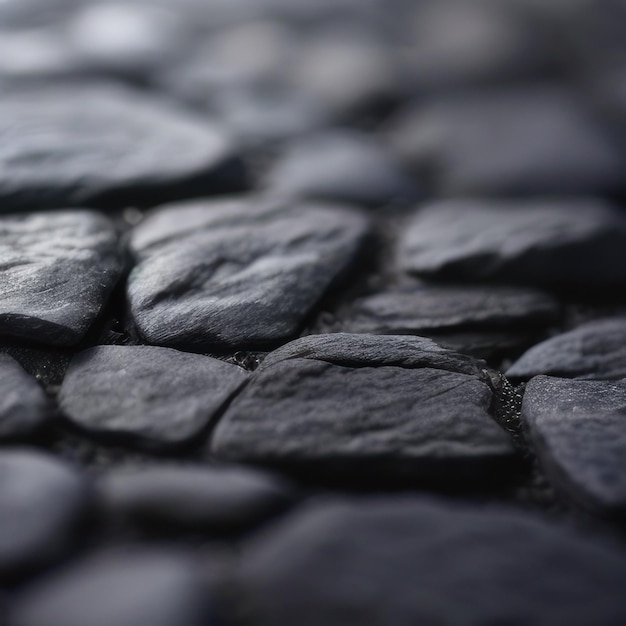 A close up of a stone floor with black stones.