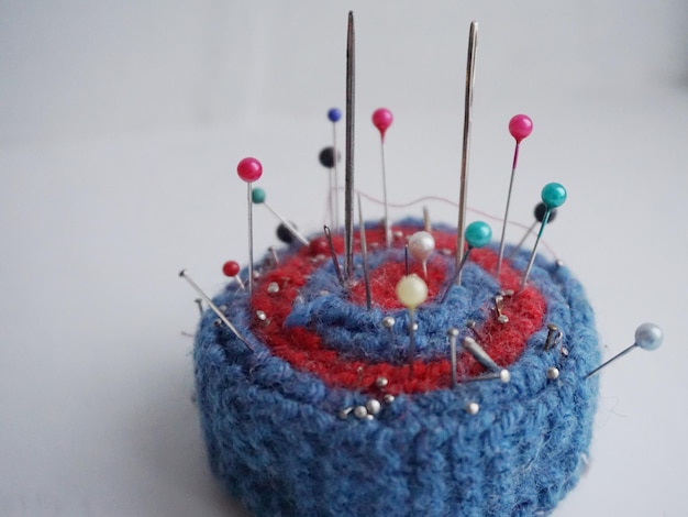 Close up of straight pins on pin cushion