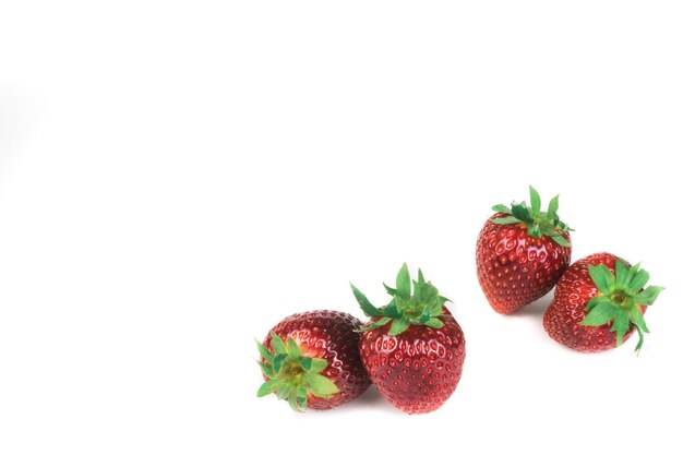 Photo close-up of strawberries against white background