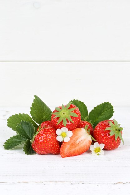 Photo close-up of strawberries on table against white background