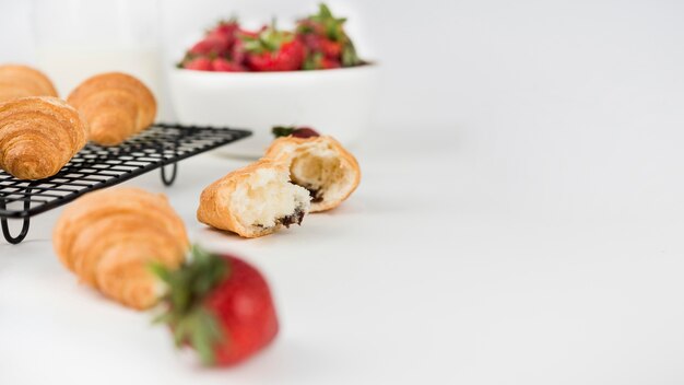 Close-up strawberries with croissants on the table