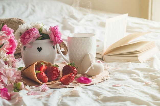 Close up strawberries with flowers on bed