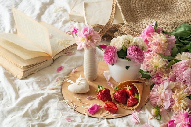 Close up strawberries with flowers on bed