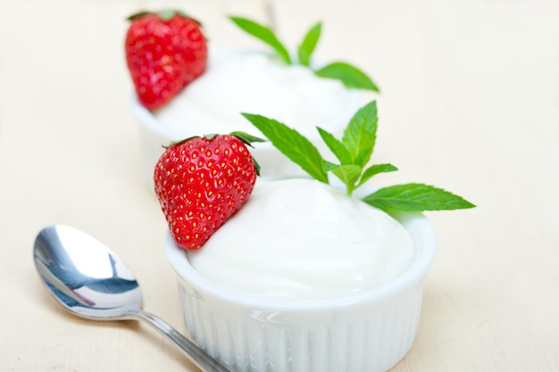 close-up of strawberries and yogurt in bowl by spoon