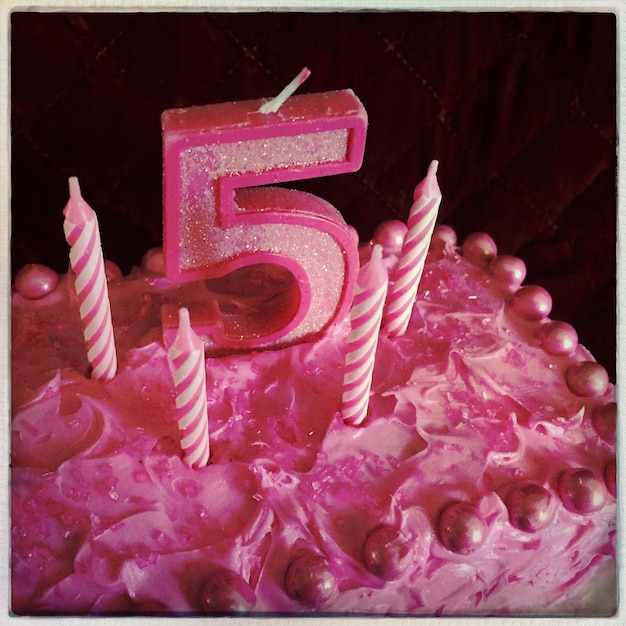 Close-up of strawberry cake with candle