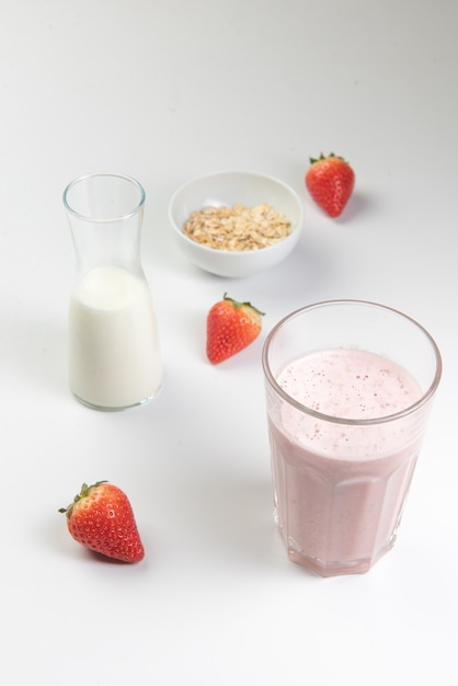 Close up of a strawberry smoothie with milk and oats