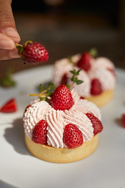 Close up strawberry tarts with cream sauce