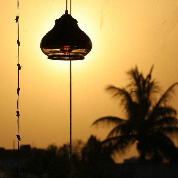 Close-up of street light against sky during sunset