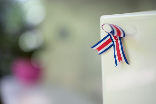 Close-up of striped ribbon on whiteboard outdoors