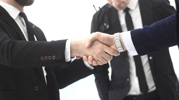 Close up.strong handshake of business partners in the office