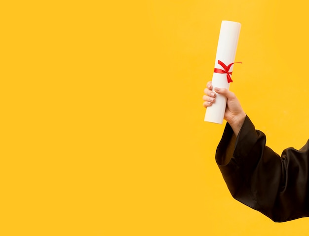 Close-up student holding diploma