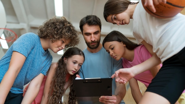 Close up students and teacher discussing