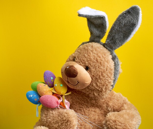 Close-up of stuffed toy against yellow background