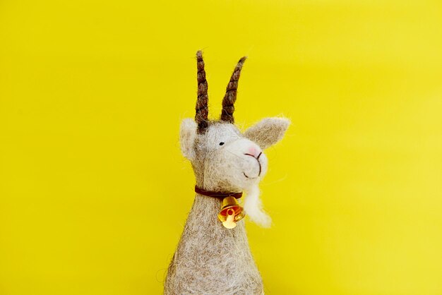 Close-up of stuffed toy against yellow background