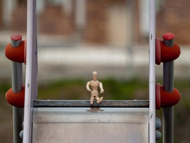 Photo close-up of stuffed toy on metal structure