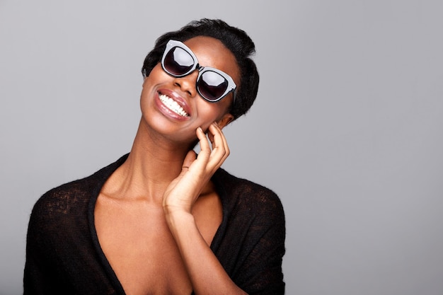 Close up stylish black woman smiling with sunglasses