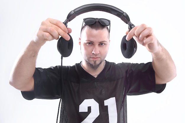 Close up stylish rapper shows headphones isolated on white