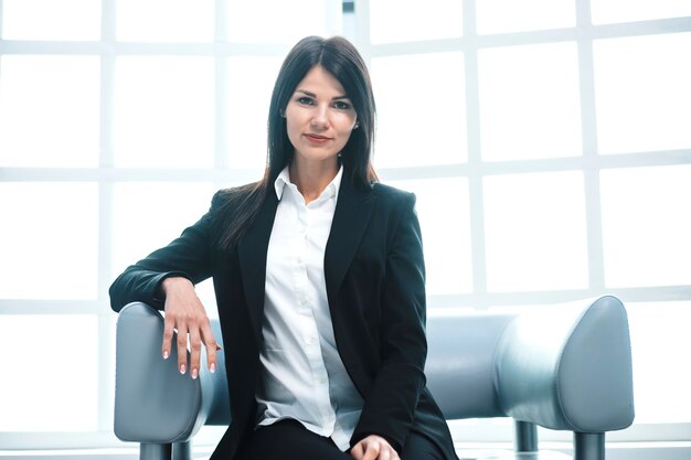 Close up. successful young business woman sitting in the office lobby