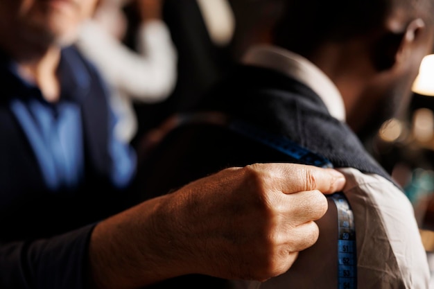 Photo close up of suitmaker doing fitting