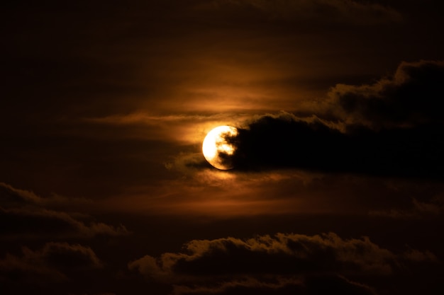 Close up the sun with cloud in front of it at the sunset twilight time.