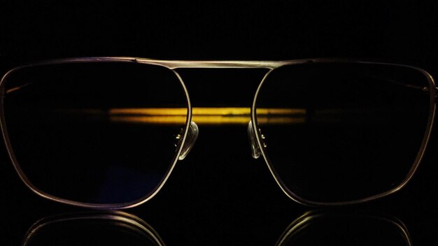 Photo close-up of sunglasses against black background