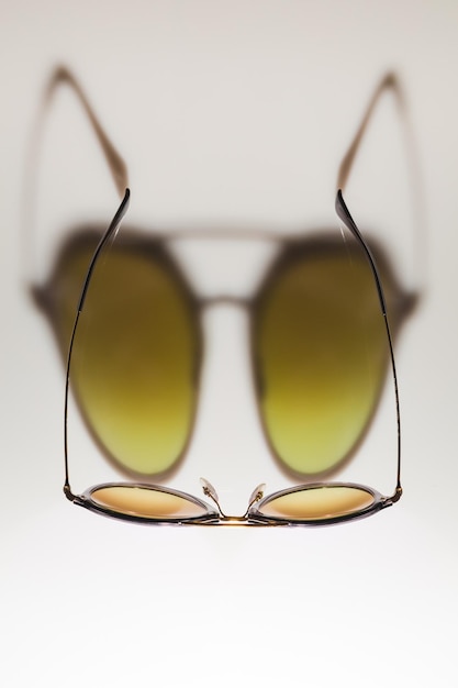 Photo close-up of sunglasses against white background