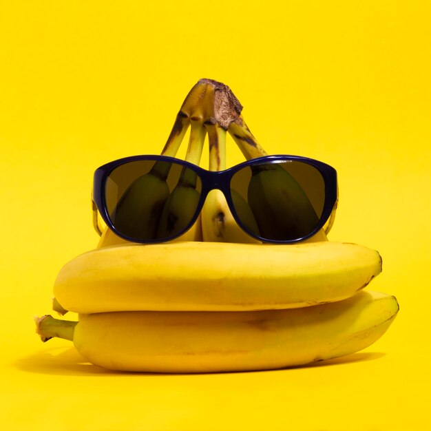 Close-up of sunglasses on banana against yellow background