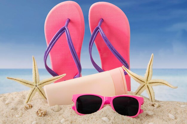 Close-up of sunglasses on beach against sky