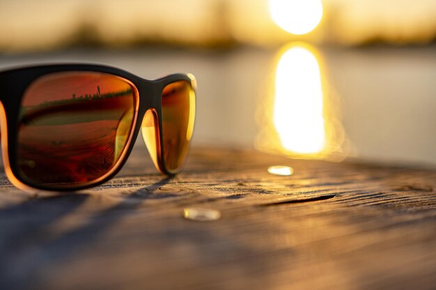 Foto close-up di occhiali da sole su un tavolo in spiaggia