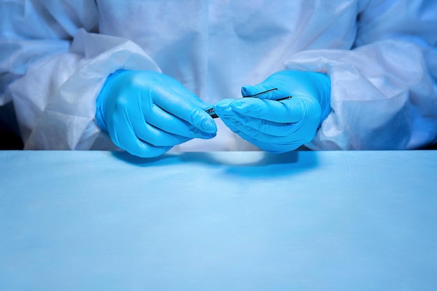 Close-up of the surgeon's hands with the instrument of dressing