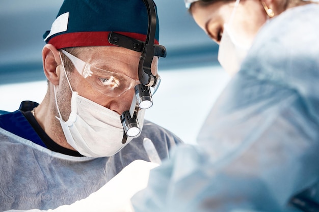 Close-up of surgeons in the operating room during the operation.Modern medicine, Medical workers during the Covid19 coronavirus pandemic fight and save lives.