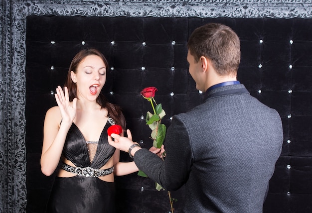 Close up Surprised Girlfriend Received a Red Rose Flower and a Red Jewelry Box of Ring from his Boyfriend.