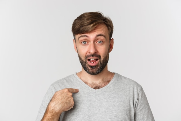 Close-up of surprised handsome man with beard