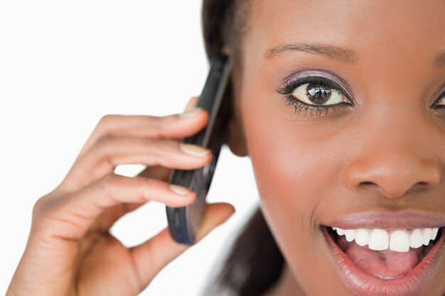 Close up of surprised woman on the phone on white background