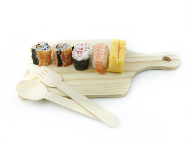 Close-up of sushi on cutting board against white background