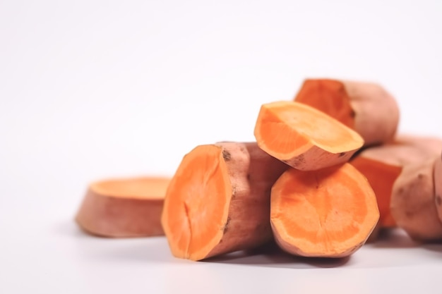 Close up of sweet potatoes on white background with copy space Healthy vegan vegetarian food concept